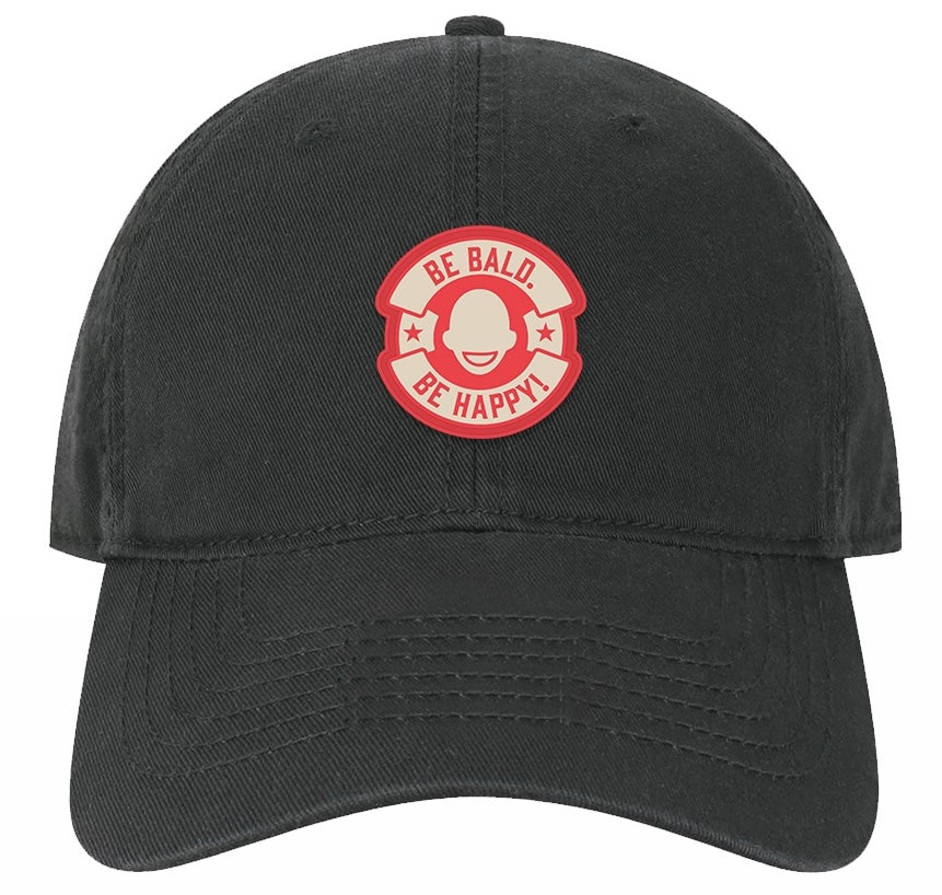 Black cap with a red and white graphic and text 'Be Bald. Be Happy!' in a circle logo.