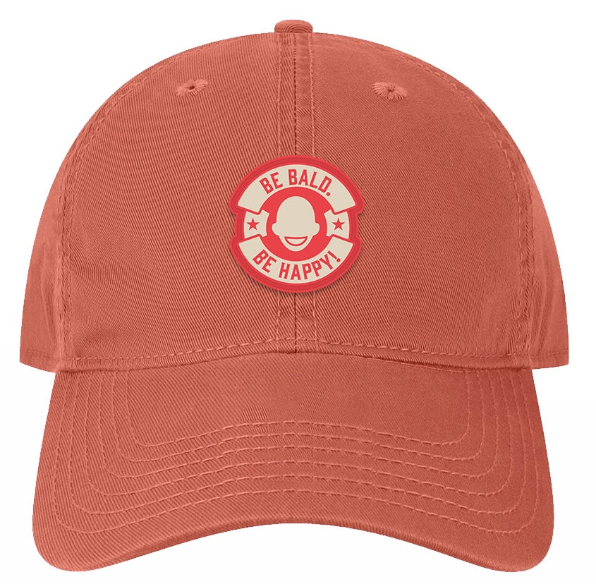 Red cap with a red and white graphic and text 'Be Bald. Be Happy!' in a circle logo.