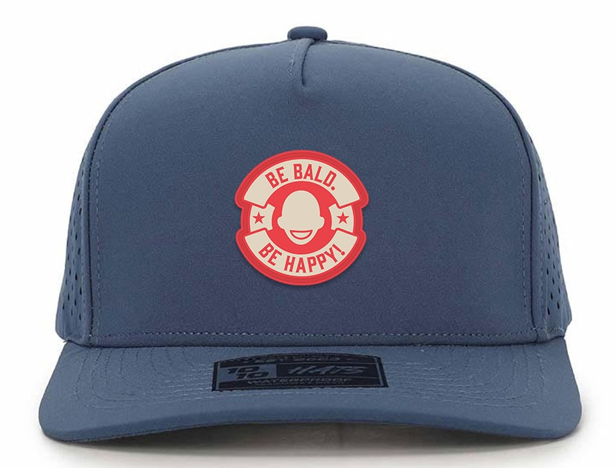 Blue cap with a red and white graphic and text 'Be Bald. Be Happy!' in a circle logo.
